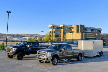Contract Equipment Operators truck and bollard installation equipment staged at a commercial site in