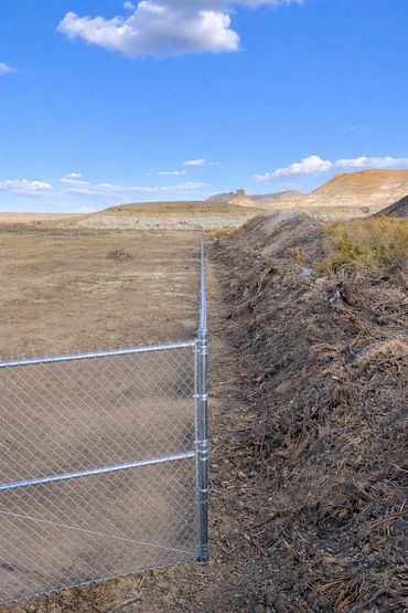 Residential chain link fence installation on a rural property in Colorado by Contract Equipment Oper