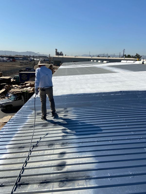 Applying a new roof coating to all the areas that were repaired or replaced