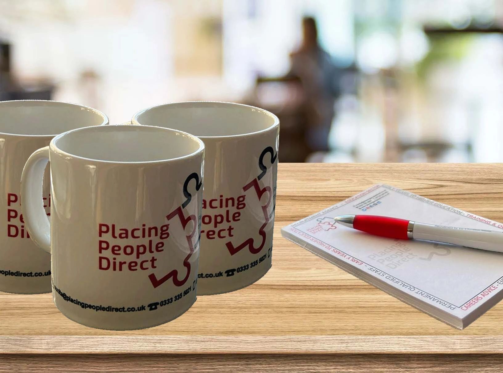 Mug, pen and paper with Placing People Direct jigsaw puzzle logos