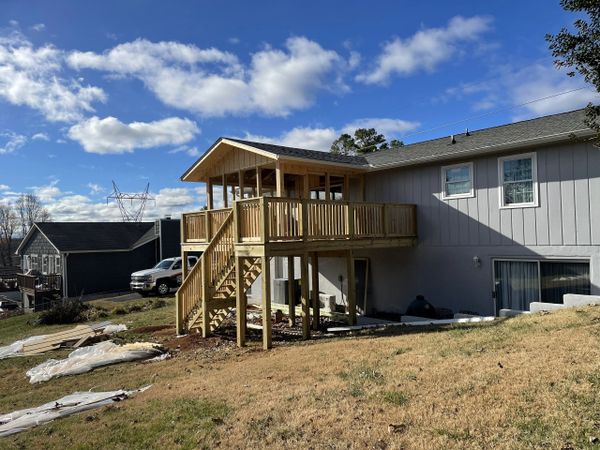 Second-story deck with screened-in porch.