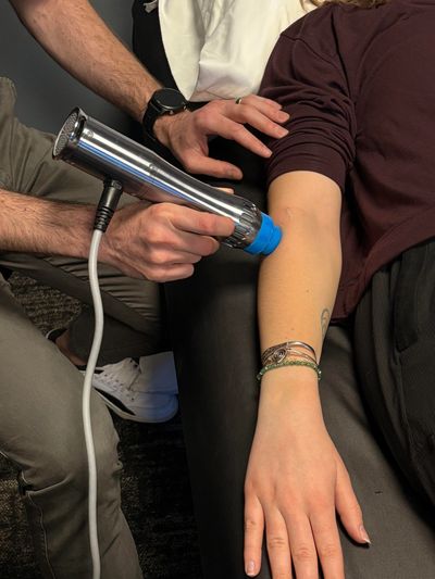 Physical therapist delivers radial shockwave therapy to a patient to stimulate natural healing
