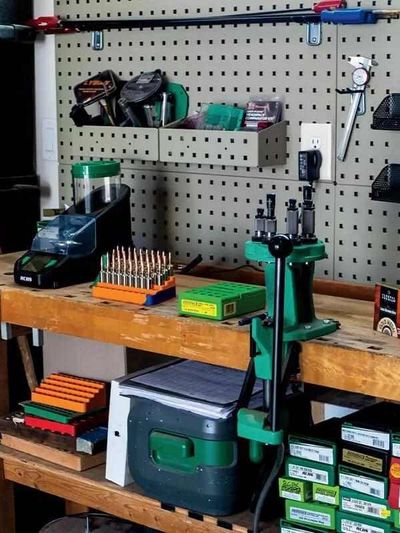 Reloading bench with gunpowder tools and components.