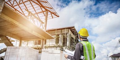 photo to symbolise the construction company. construction worker looking at a building site