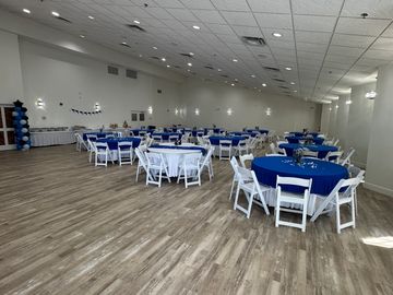 Spacious hall with tables set for an event.