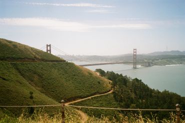 Golden Gate Bridge viewed from green hills.