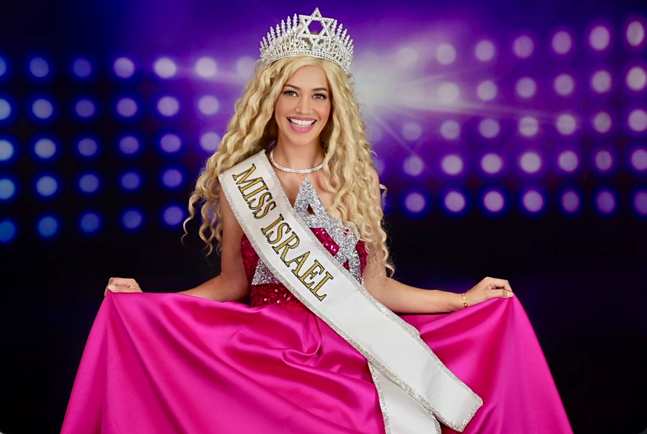 Miss Israel winner in a crown and pink gown.