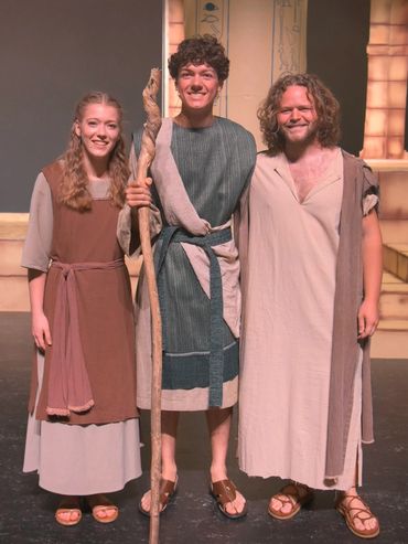 Miriam, Moses, and Aaron in biblical costumes smiling