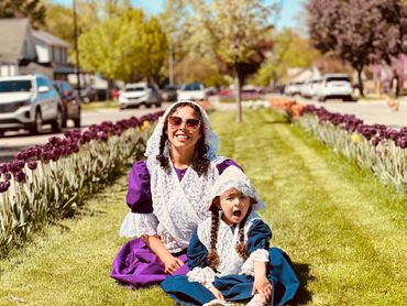 Mother & daughter in purple and blue Dutch costumes in tulip lane