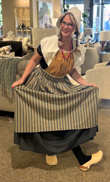 Woman wearing Dutch costume shows her wooden shoes