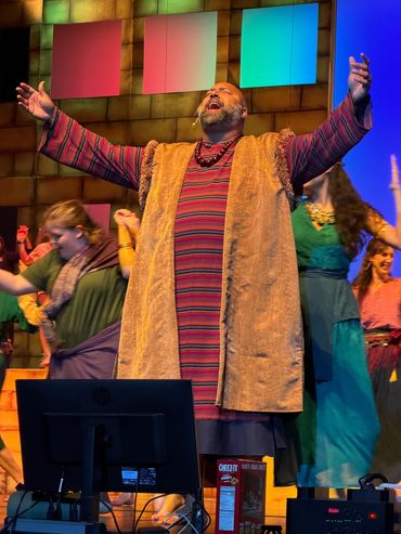 Actor in colorful stripe tunic, gold vest - Prince of Egypt