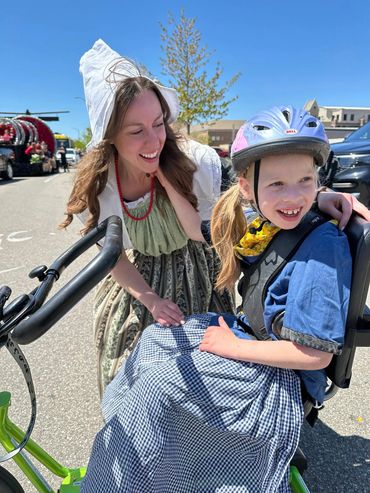 Mother and daughter with bike wearing Dutch costumes