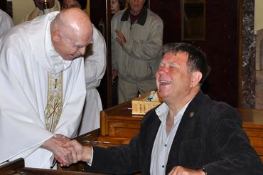 Msgr. Reilly returning from a Prayer Vigil laughing with a long-time Helper.