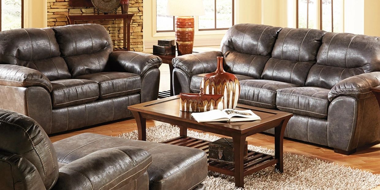 three leather sofas in a room 