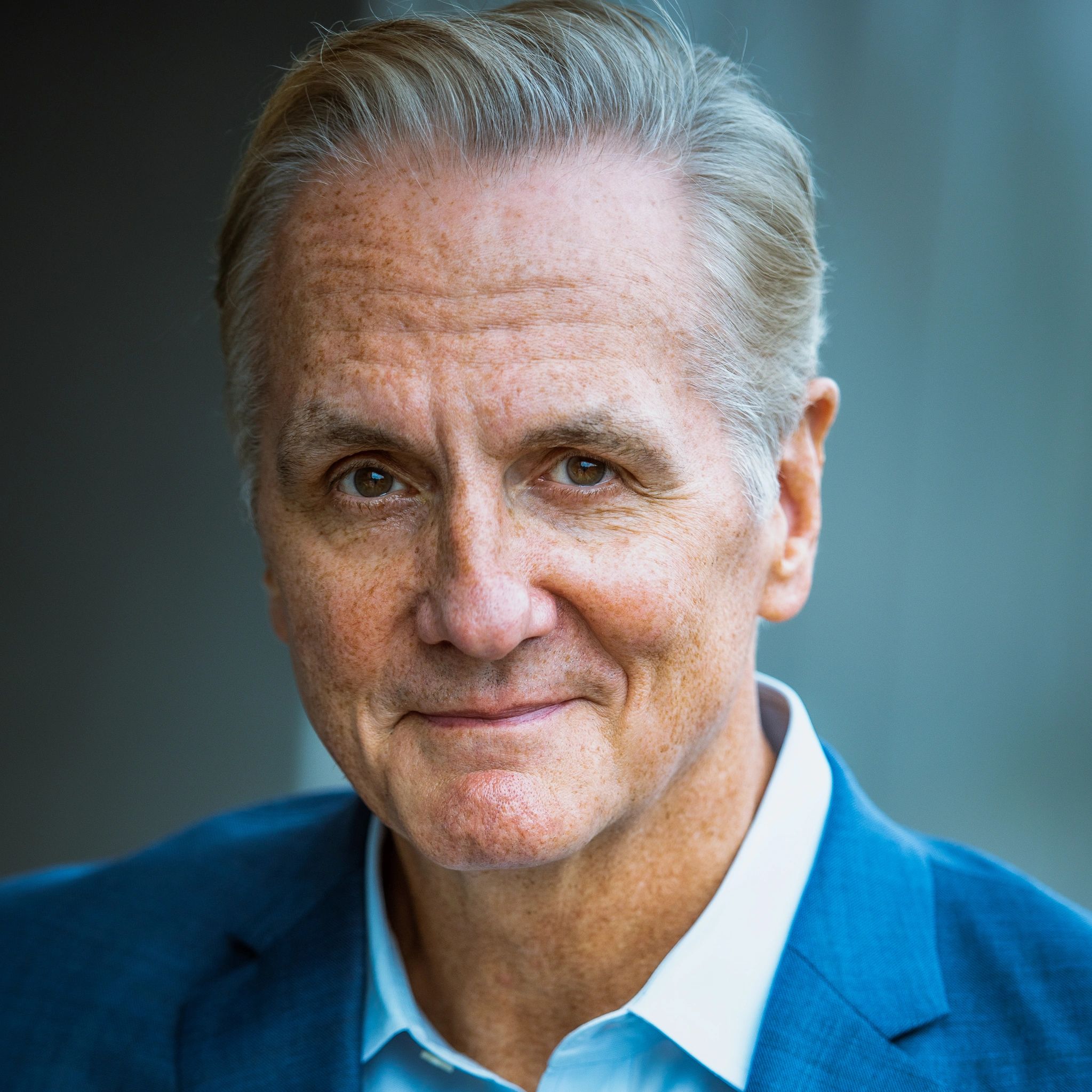 A headshot portrait of an elderly man