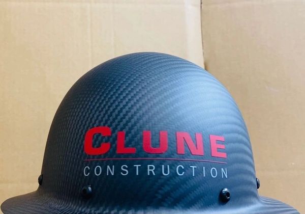 A hard hat with a text clune construction written on it