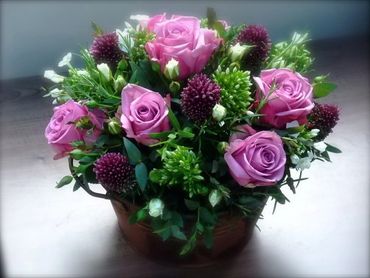 A gift arrangement in a container. Simple for the recipient to display