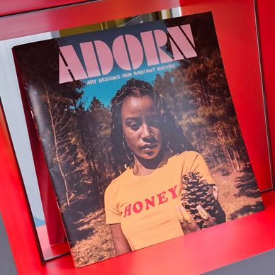 Magazine cover featuring a woman holding a pinecone.
