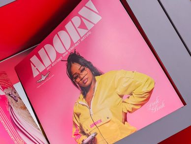 Magazine cover featuring a young woman in a yellow jacket.