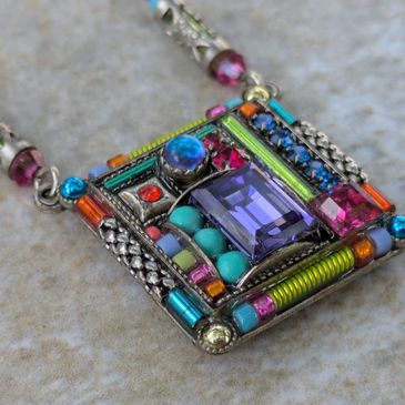 Colorful gemstone pendant with intricate design and vibrant beads by the designers of Firefly jewelry.