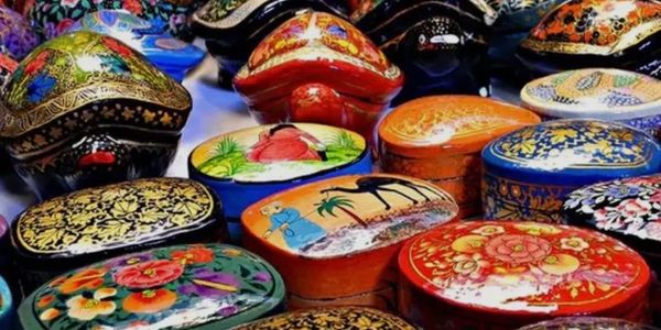 Colorful, hand-painted decorative boxes with intricate floral and scenic designs.