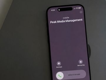Smartphone receiving a call from Peak Media Management.