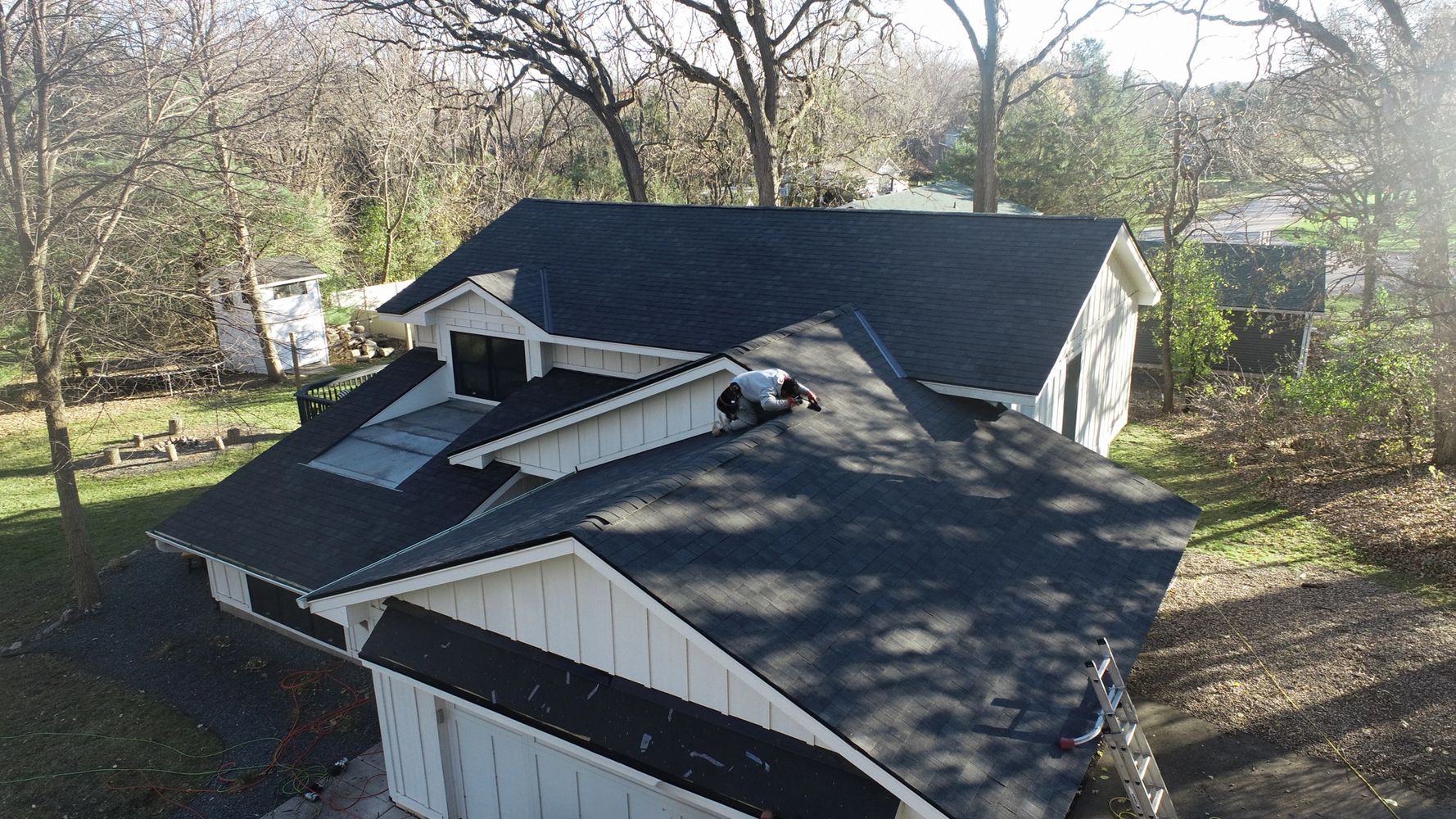 Stack of books next to pencils in a holder and a camera.