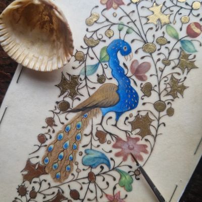 A detailed painting of a blue peacock on floral patterned paper.