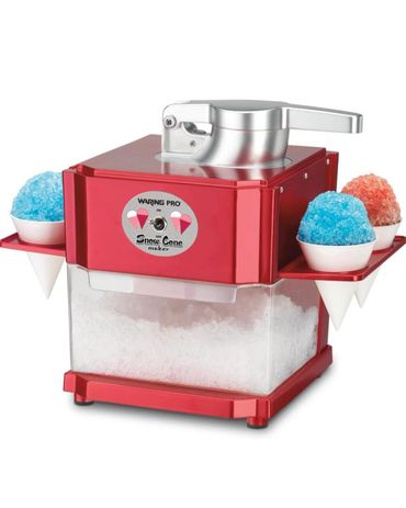 Red Waring Pro snow cone maker with shaved ice and syrup cups.
