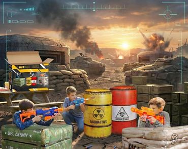 Three kids play with toy guns in a war-themed setting with barrels and sandbags.