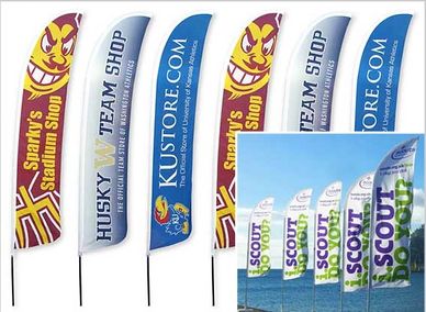 Multiple colorful promotional flags advertising various shops and a scout event.
