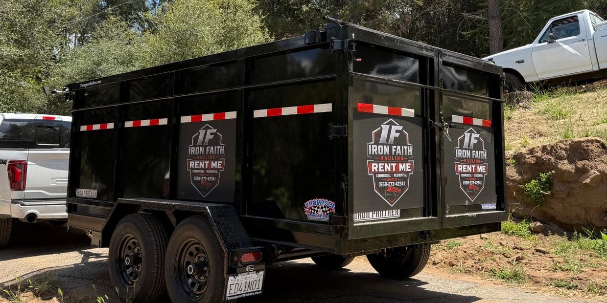 Black hauling trailer with Rent Me signs.
