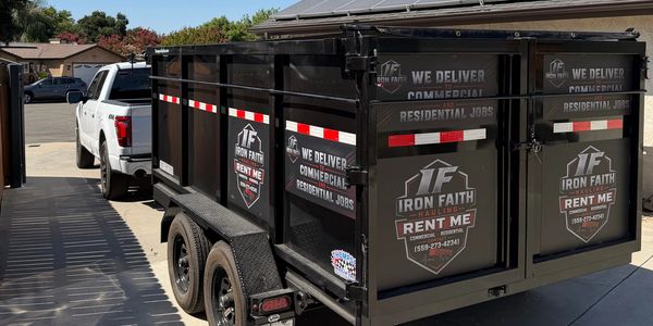 Black Iron Faith haul trailer attached to white truck.