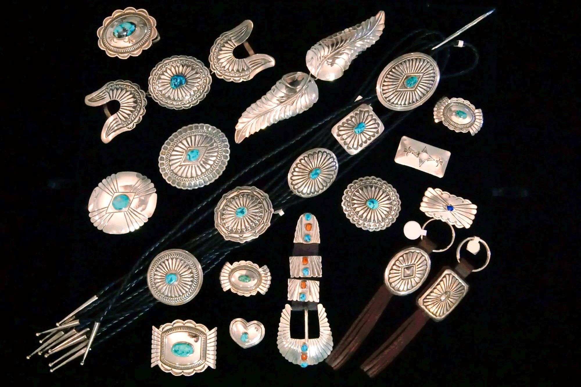 Grouping of navajo silver stampwork with turquoise, horizontal case