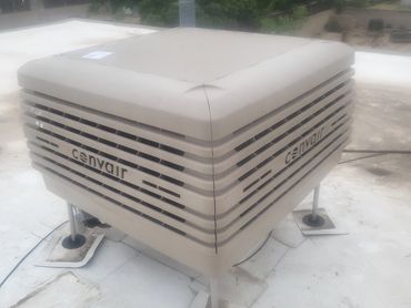 A beige Convair rooftop air conditioning unit on a flat roof.