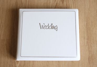 white wedding album on desk