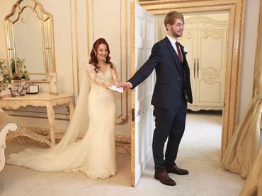 bride + groom standing apart at Gosfield Hall