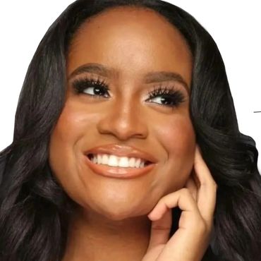 Smiling woman with flawless makeup and styled black hair.