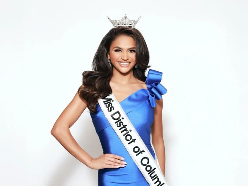 Miss District of Columbia pageant winner in blue dress and crown.
