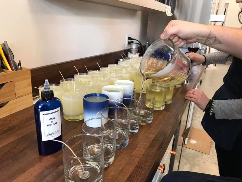 Hand pouring soy wax candles - Owosso Candles