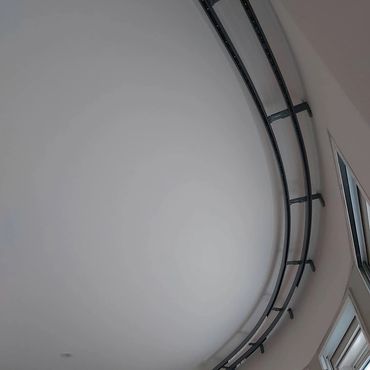 Curved window poles and tracks.