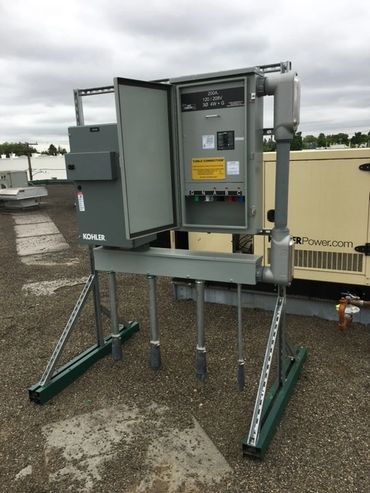 Electrical cabinet, industrial outdoor control panel set on a gravel parking lot
