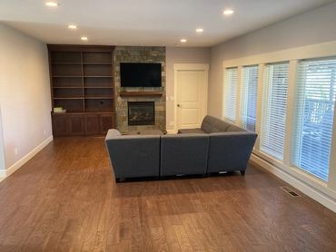 Living room with couch, fireplace and recessed ceiling lights