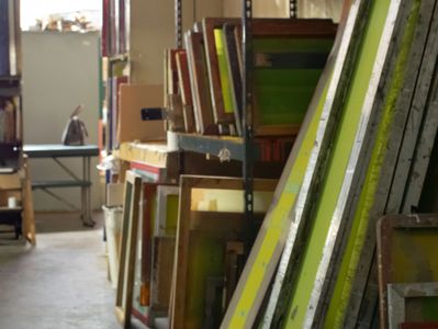 An industrial shelving array showing silk screens of various sizes and mesh types.