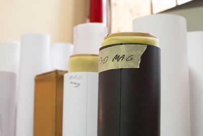 A group of tubes of roll media for printing, ranging from plain paper to magnet.