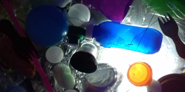 Installation piece of bottles floating in water from all at sea show