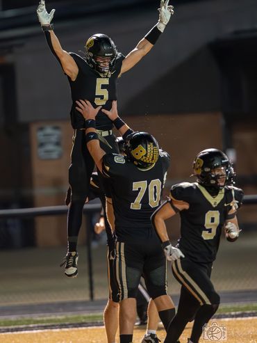 Boonville High School football players celebrate a touchdown.