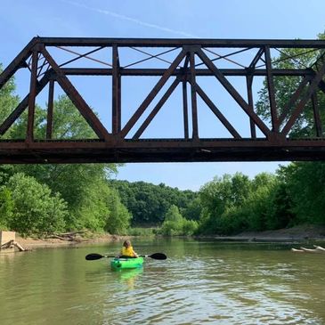 Kayak under the iron train bridge