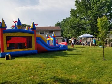 Top Flight Inflatables Combo Bounce House set up at Birthday party on a hot Summer Day.