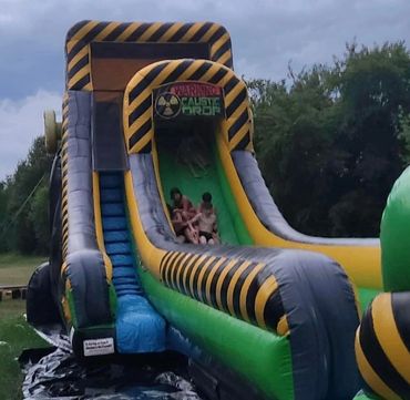 A group of brothers and sisters sliding down the Caustic Slide!